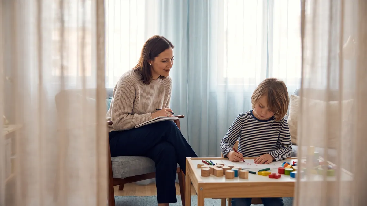 Child and adolescent psychologist observing a child during a family assessment