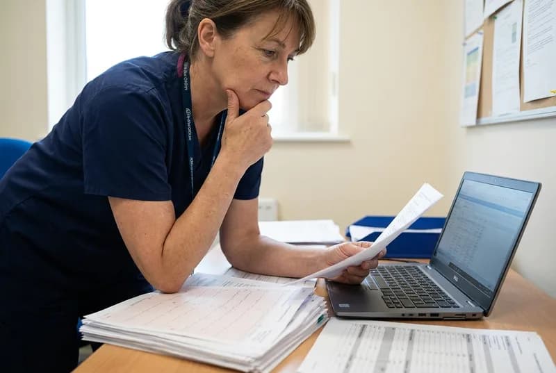 Doctor comparing medical records to assess causation for a medico-legal report